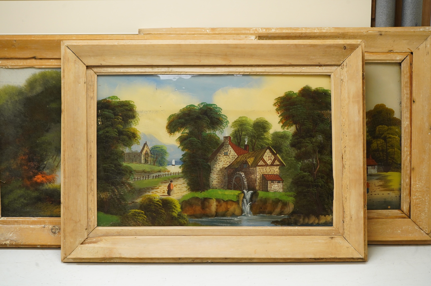 Victorian School, set of three reverse glass painted panels, Riverscapes, 38 x 59cm